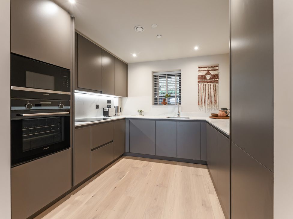 A kitchen with cabinets, oven and sink at tbc in St. Ives