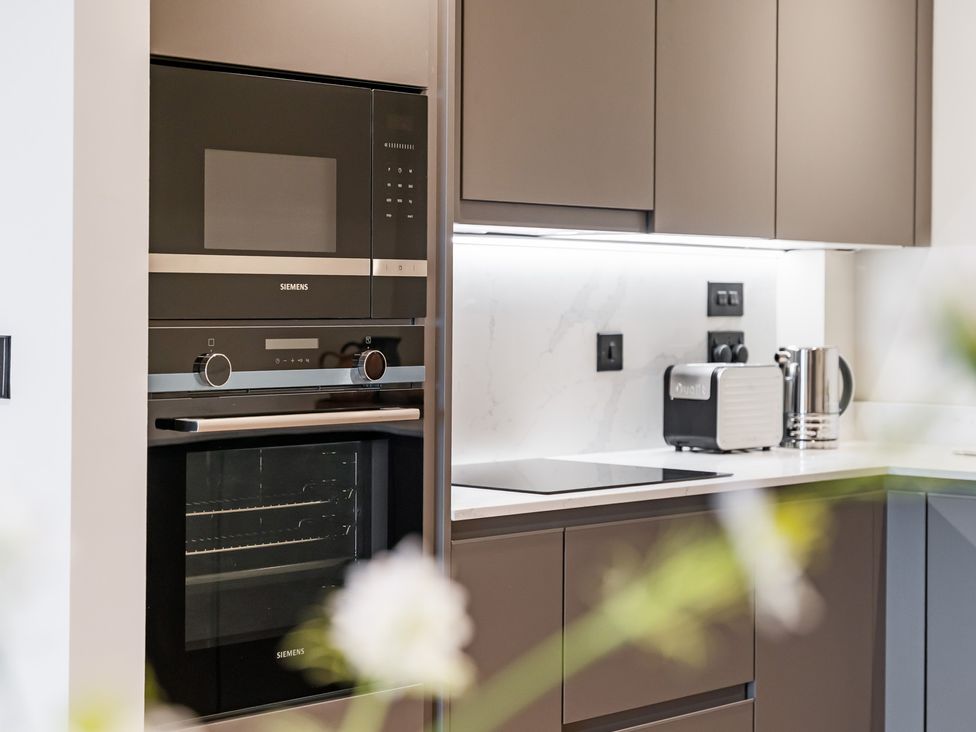 A kitchen with an oven and microwave at tbc in St. Ives