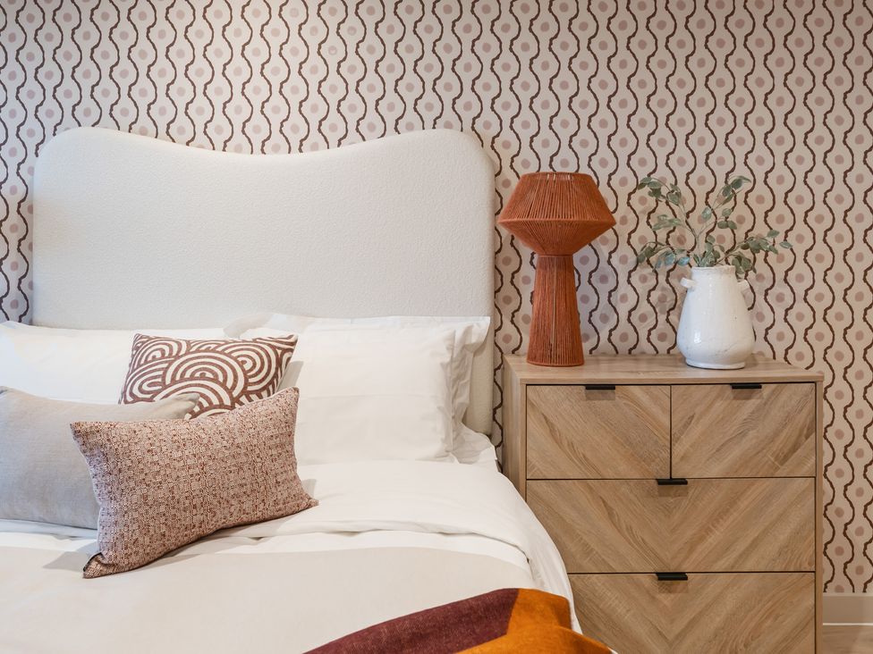 A bedroom with a bed and a nightstand at tbc in St. Ives