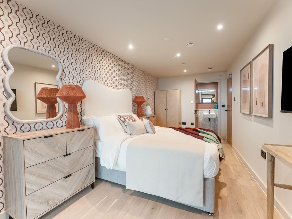 A bedroom with a bed and bedside tables at tbc, St. Ives