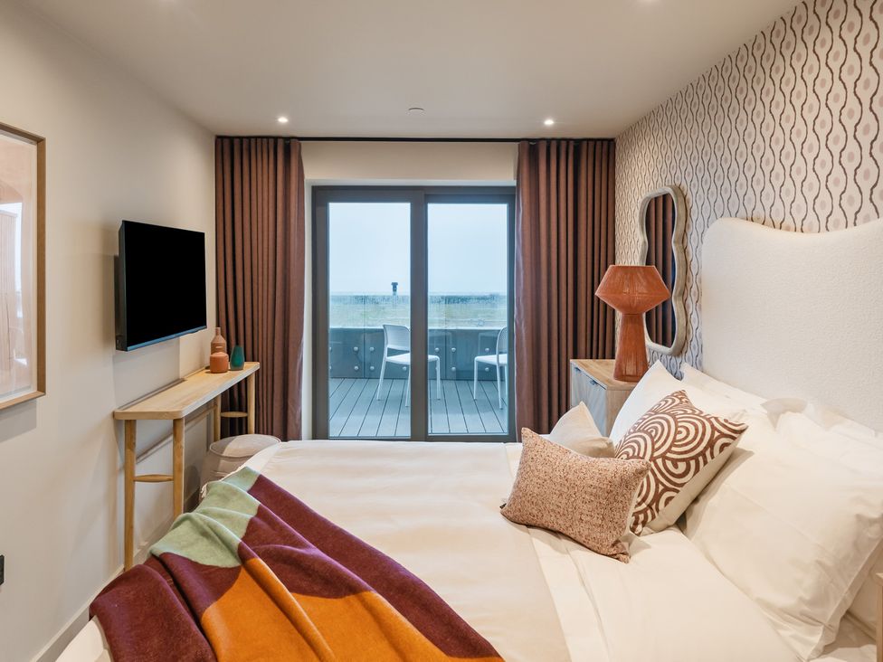 A bedroom with a bed and television at tbc in St. Ives