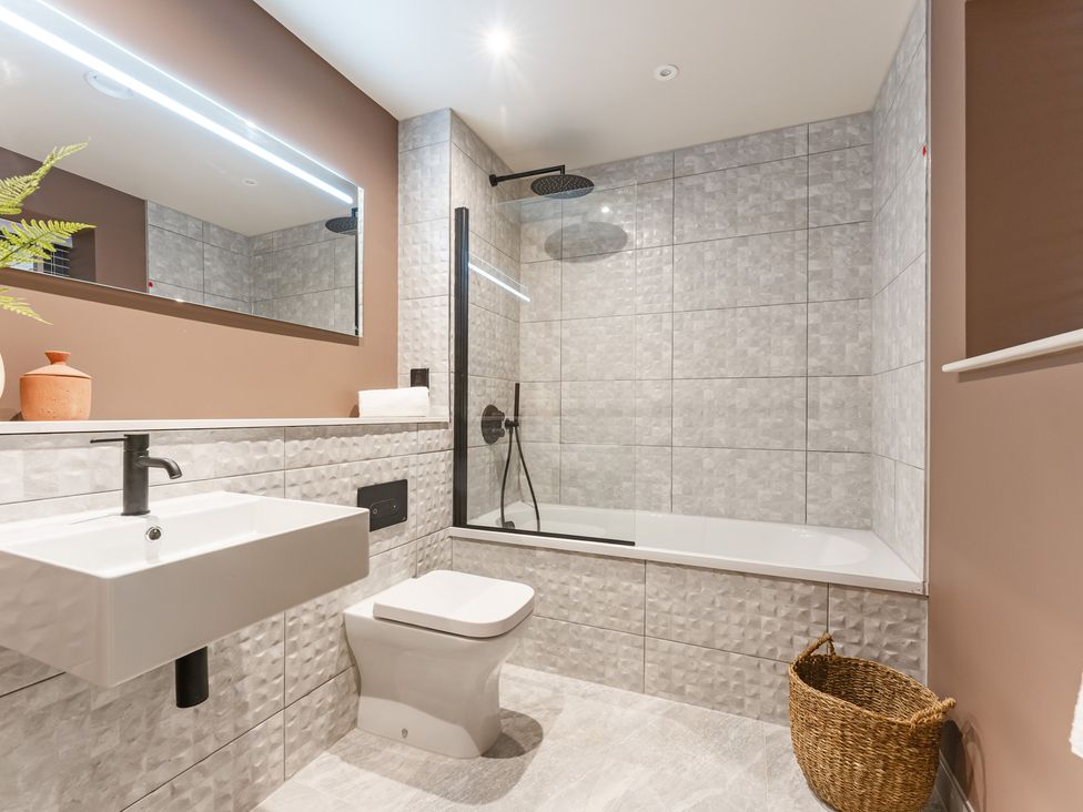 A bathroom with a sink, toilet, and shower at tbc in St. Ives