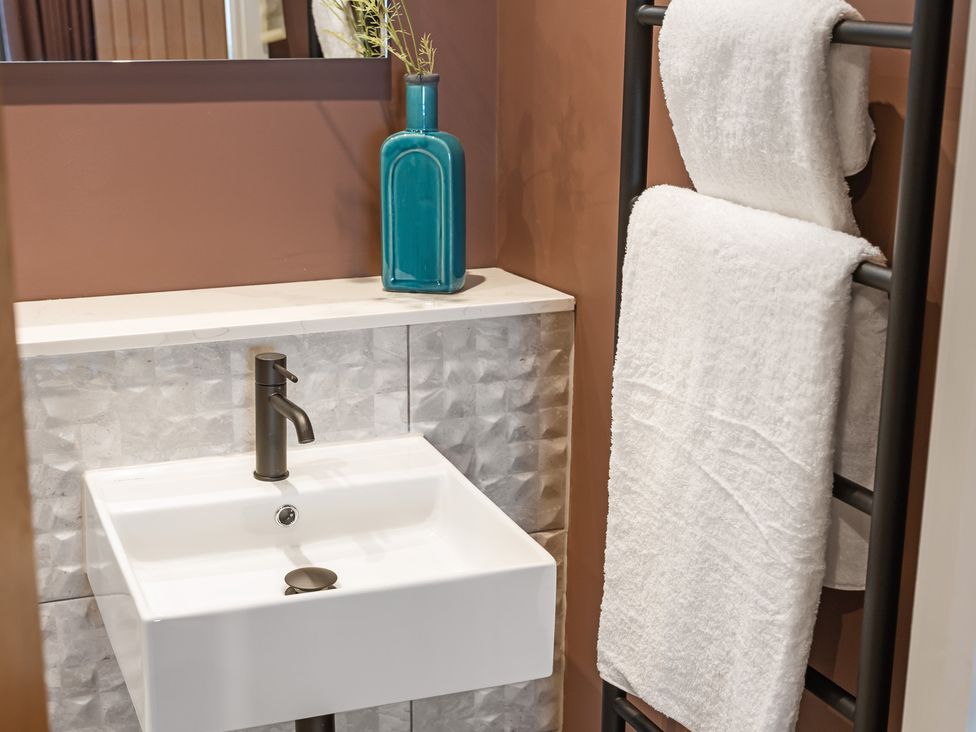 A bathroom with a sink and towels at tbc St. Ives