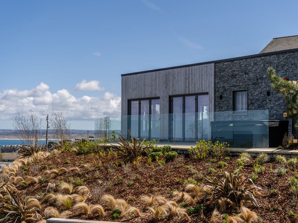 An outdoor area with a stone and wooden exterior at Hidden 12- Hot Tub Terrace St Ives