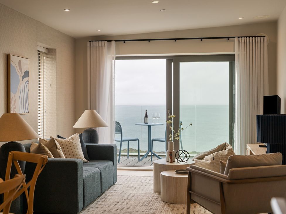 A living room with a sofa and a sliding door at tbc in St. Ives