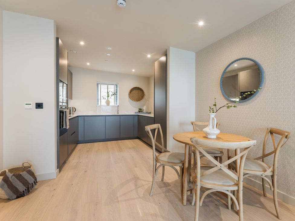 A kitchen with a dining table and chairs at tbc in St. Ives
