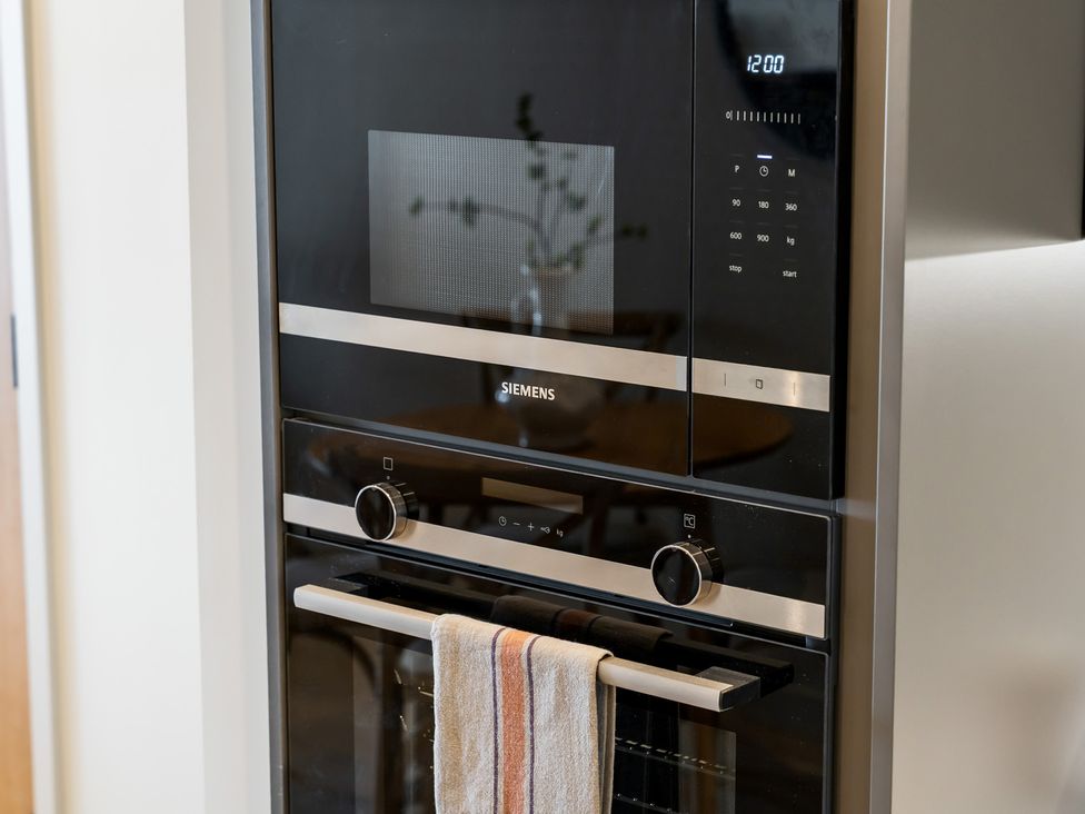 A microwave and oven combination unit in a kitchen at tbc in St. Ives