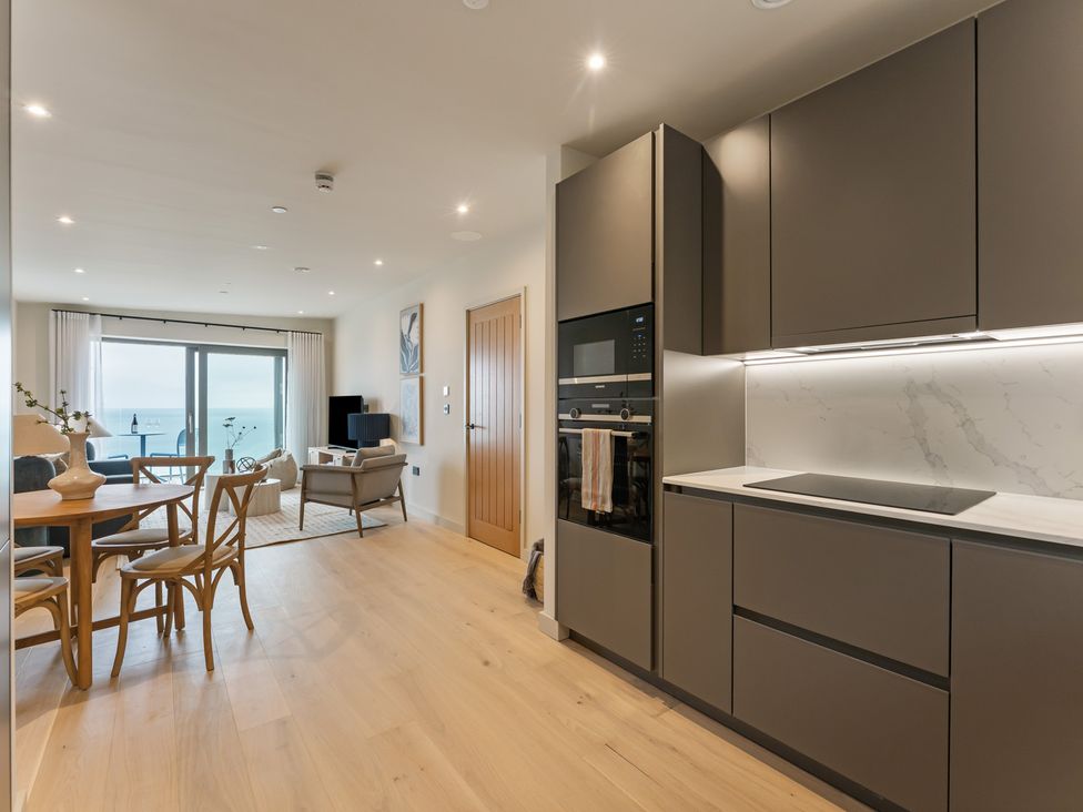 A living room with a dining area and kitchen features at tbc St. Ives