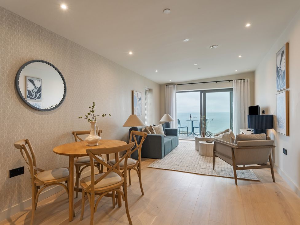 A living room with a table and chairs at tbc in St. Ives