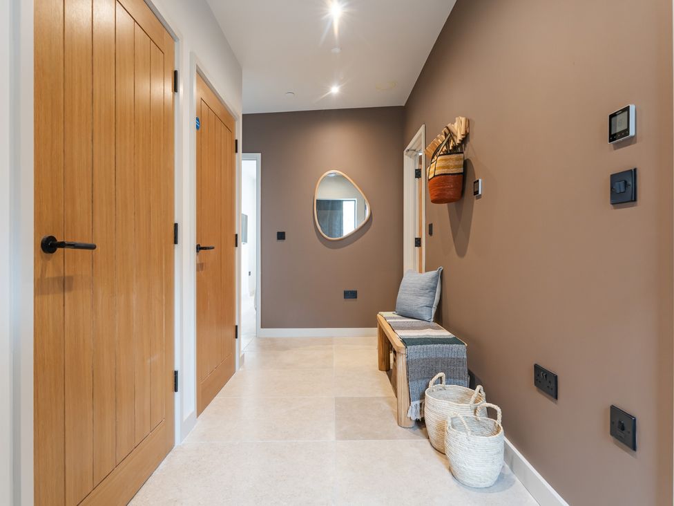 A hallway with doors and a bench at tbc in St. Ives