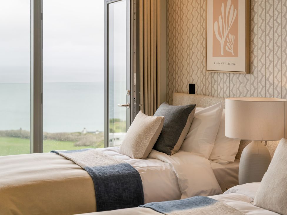 A bedroom with two beds and a view at tbc in St. Ives