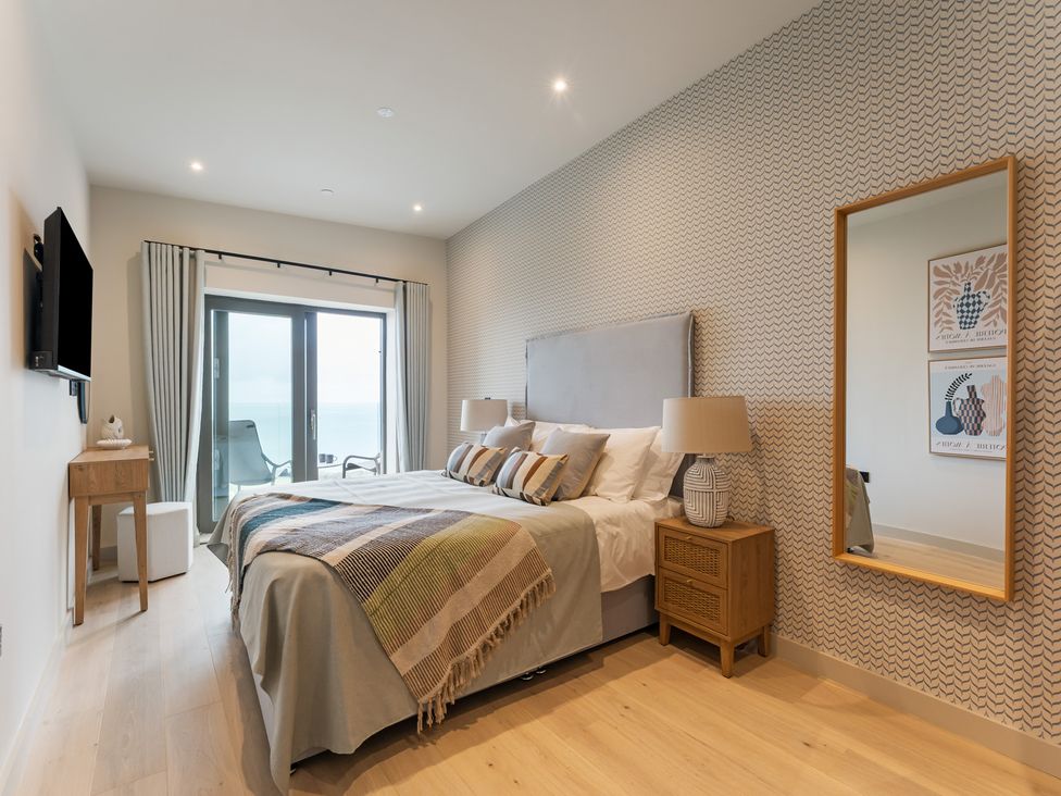 A bedroom with a bed and television at tbc in St. Ives