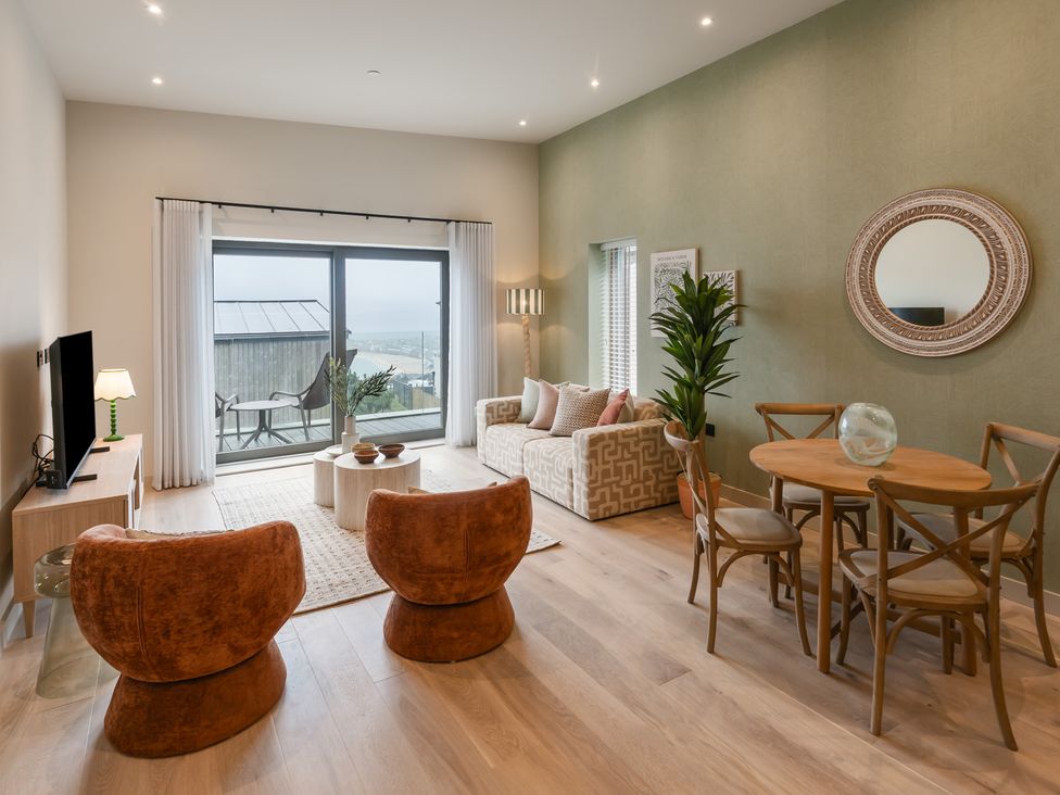 A living room with a sofa and chairs at tbc in St. Ives