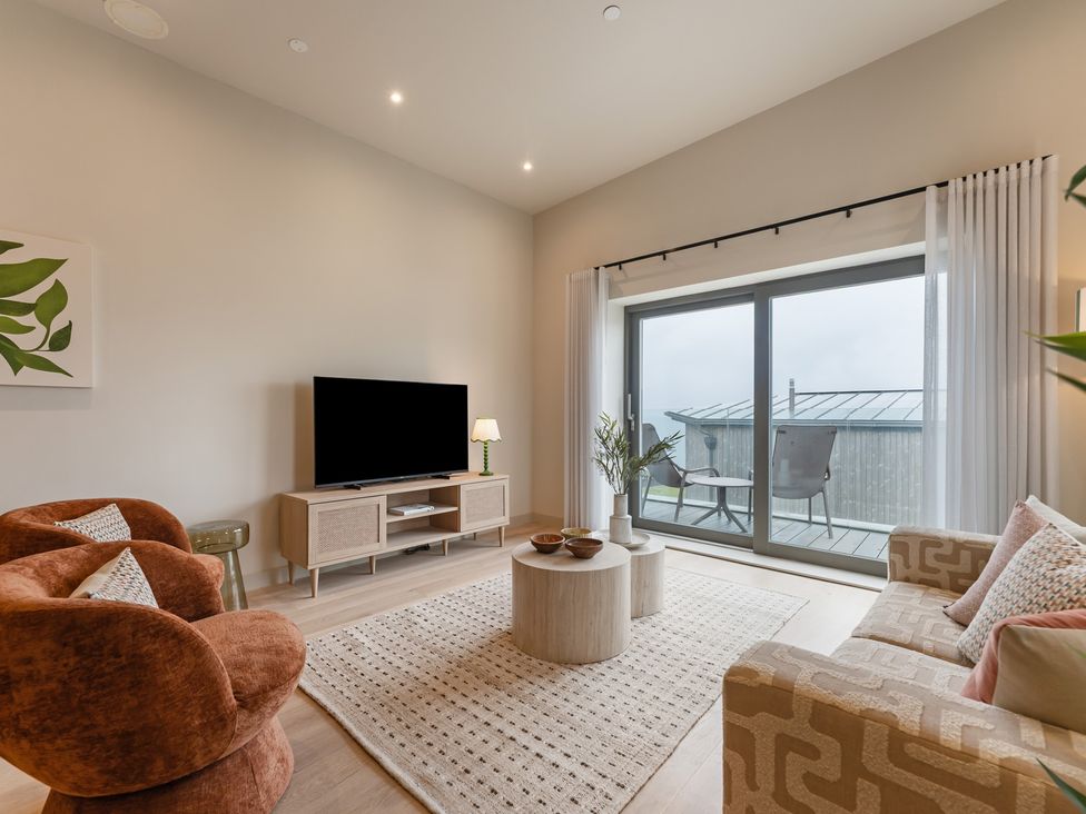 A living room with a television, sofa, and coffee table at tbc in St. Ives