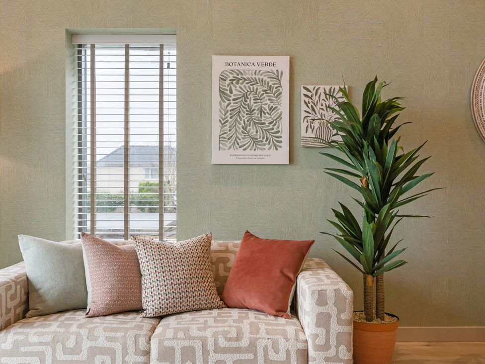 A living room with a sofa and decorative items at tbc in St. Ives