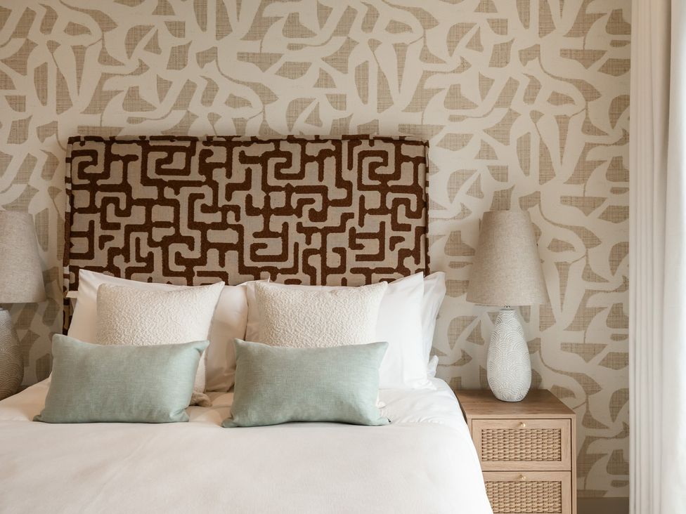 A bedroom with a bed and decorative headboard at tbc St. Ives