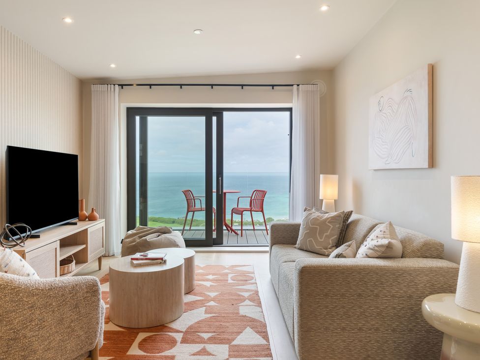A living room with a sofa and a coffee table at Hidden 10- Godrevy View in St Ives