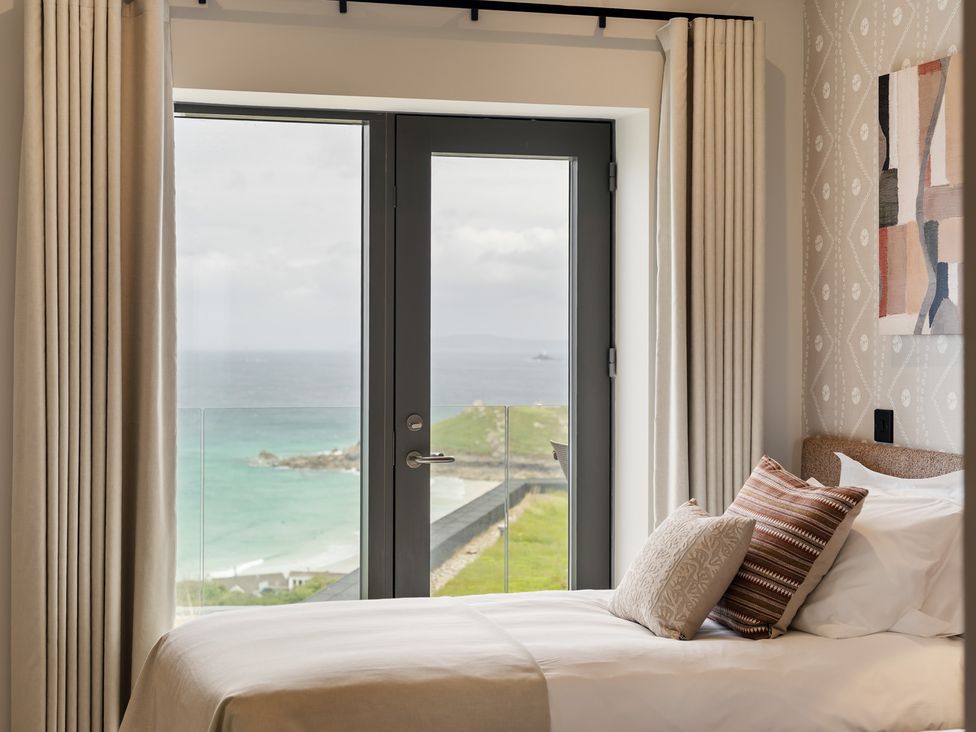 A bedroom with a view of the ocean at Hidden 10- Godrevy View, St Ives