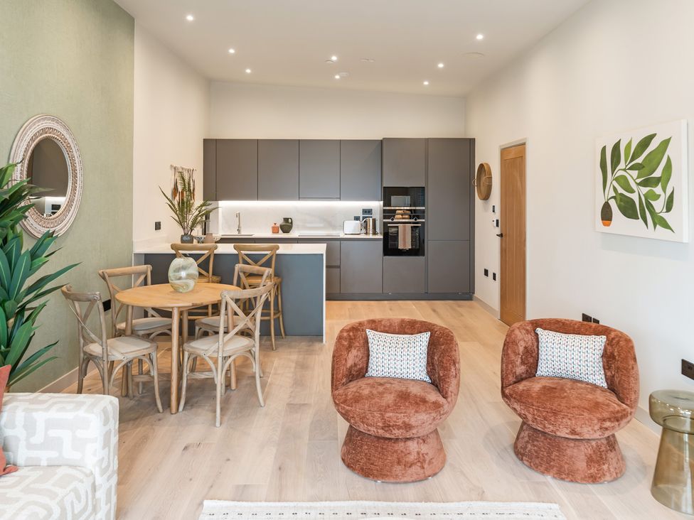 A living room with a dining area and kitchen at tbc in St. Ives