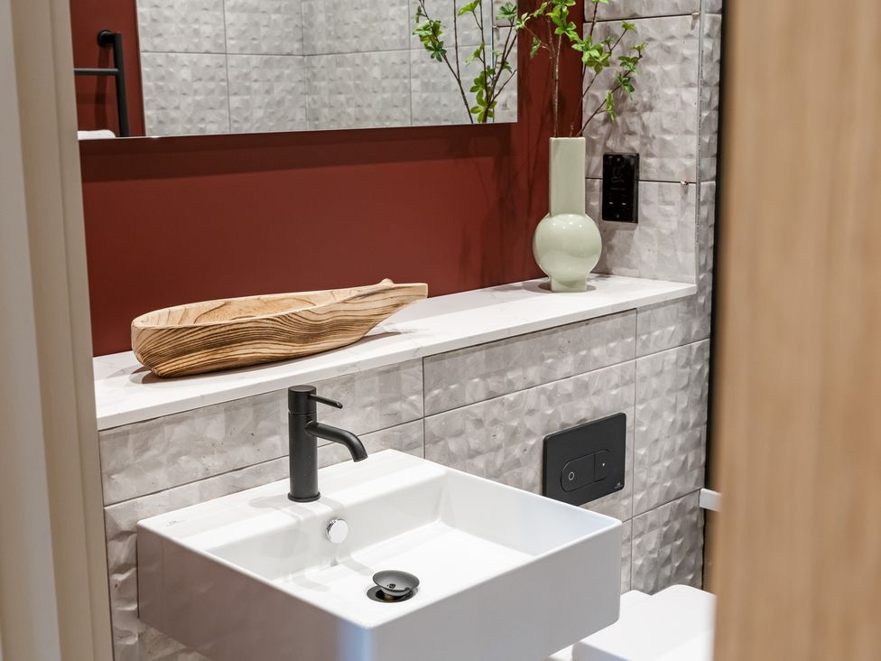 A bathroom with a sink and wooden bowl at tbc in St. Ives