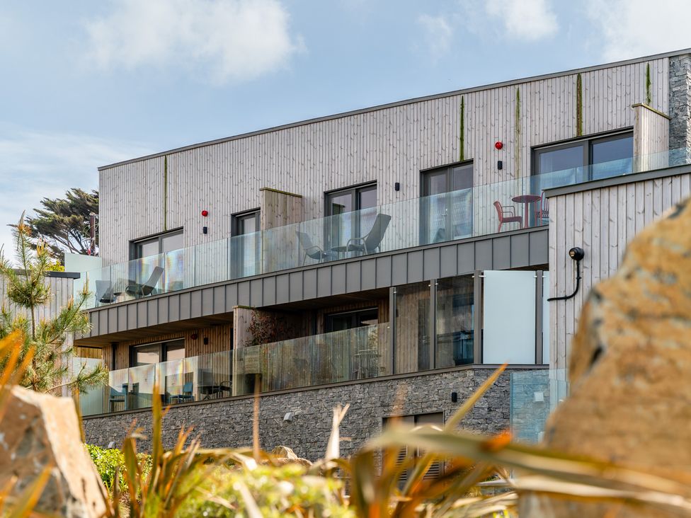 A building with balconies and glass railings at Hidden 11- Porthmeor View St Ives