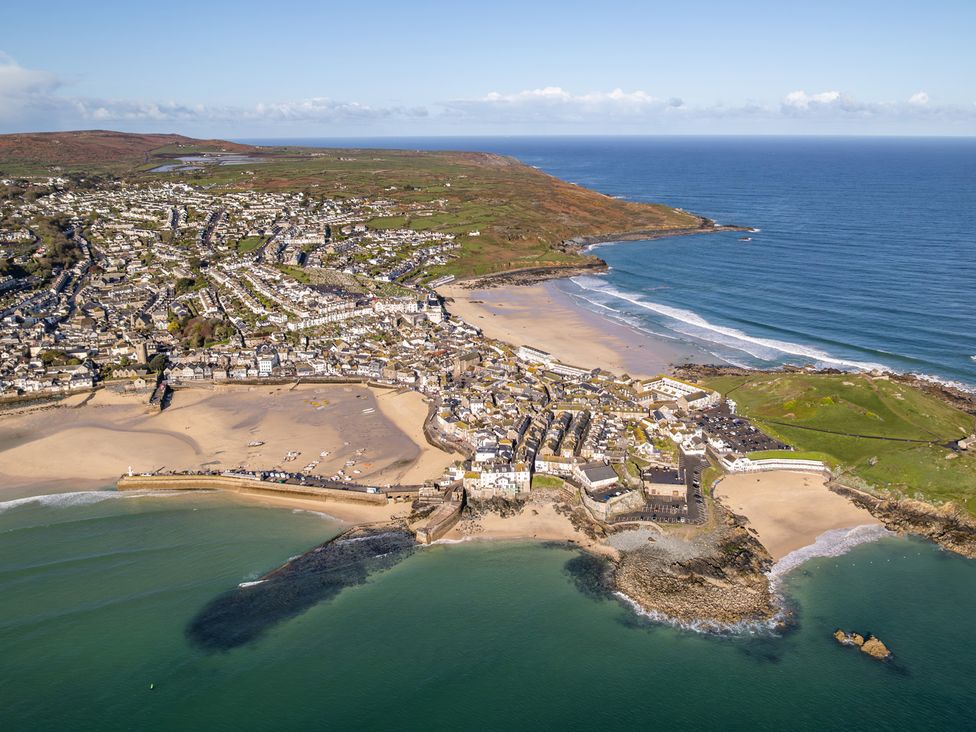 An aerial view of a coastal town near the beach at Hidden 11- Porthmeor View, St Ives