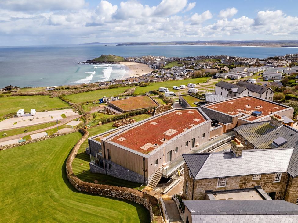 An aerial view of a beach and houses at tbc St. Ives