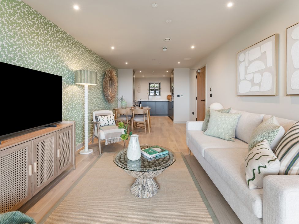 A living room with a television, sofa, and coffee table at tbc in St. Ives