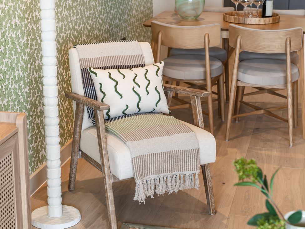 A chair with a pillow and blanket in a dining area at tbc in St. Ives