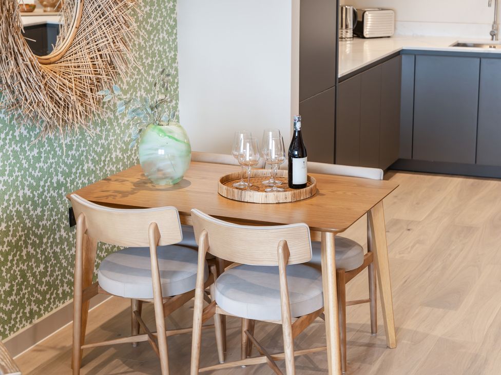 A dining room with a table and chairs at tbc in St. Ives