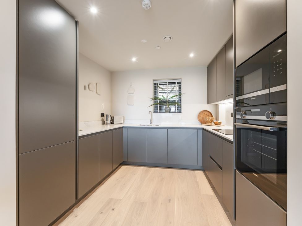 A kitchen with cabinets, sink, and appliances at tbc in St. Ives