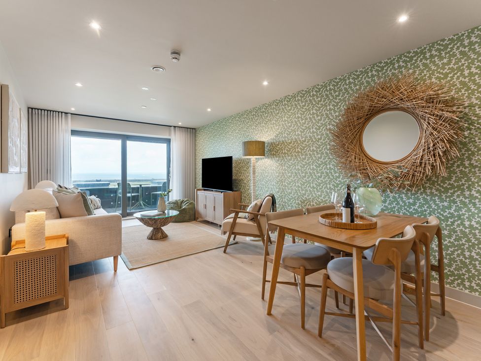 A living room with a dining area and a view at tbc in St. Ives