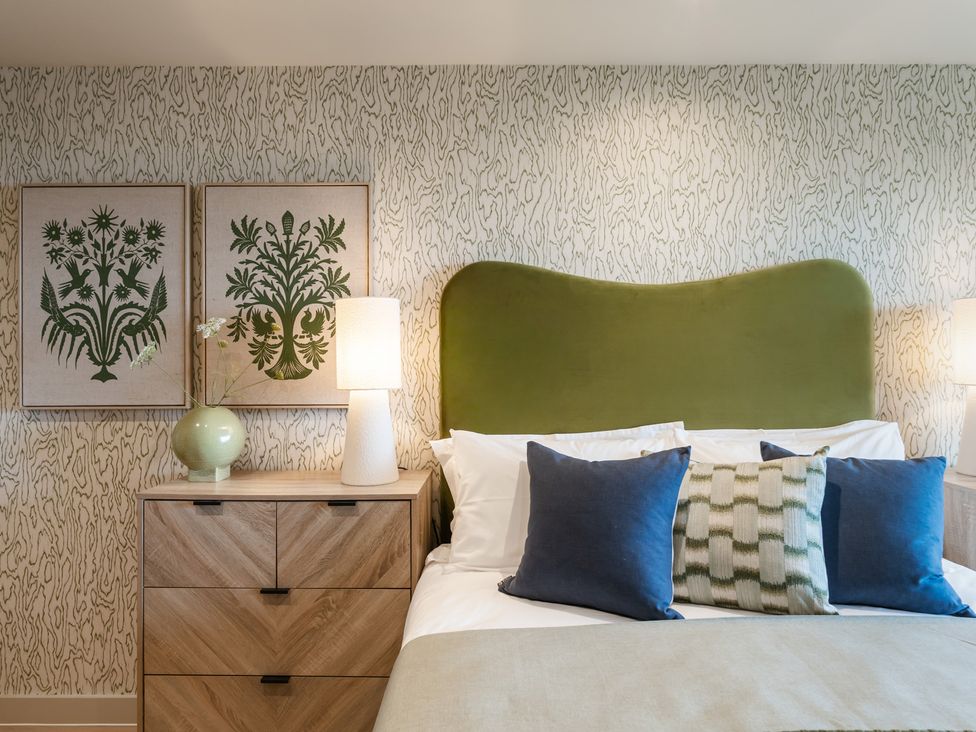 A bedroom with decor and a bed at The Old Barn in St. Ives
