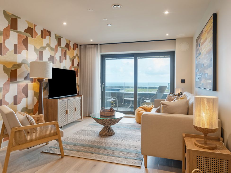 A living room with a television and sofa at tbc in St. Ives