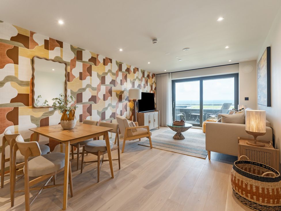 A living room with a table and chairs at tbc in St. Ives
