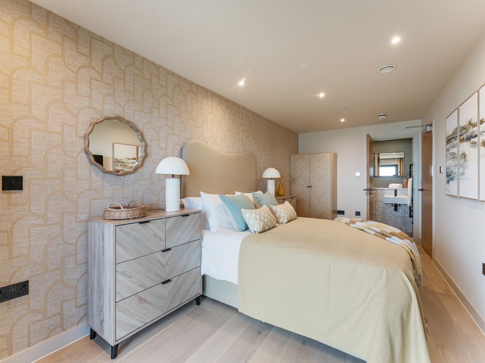 A bedroom with a bed and nightstand at tbc in St. Ives