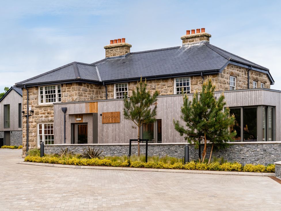 A modern building with stone and wood exterior at Hidden 14- Garden Terrace St Ives