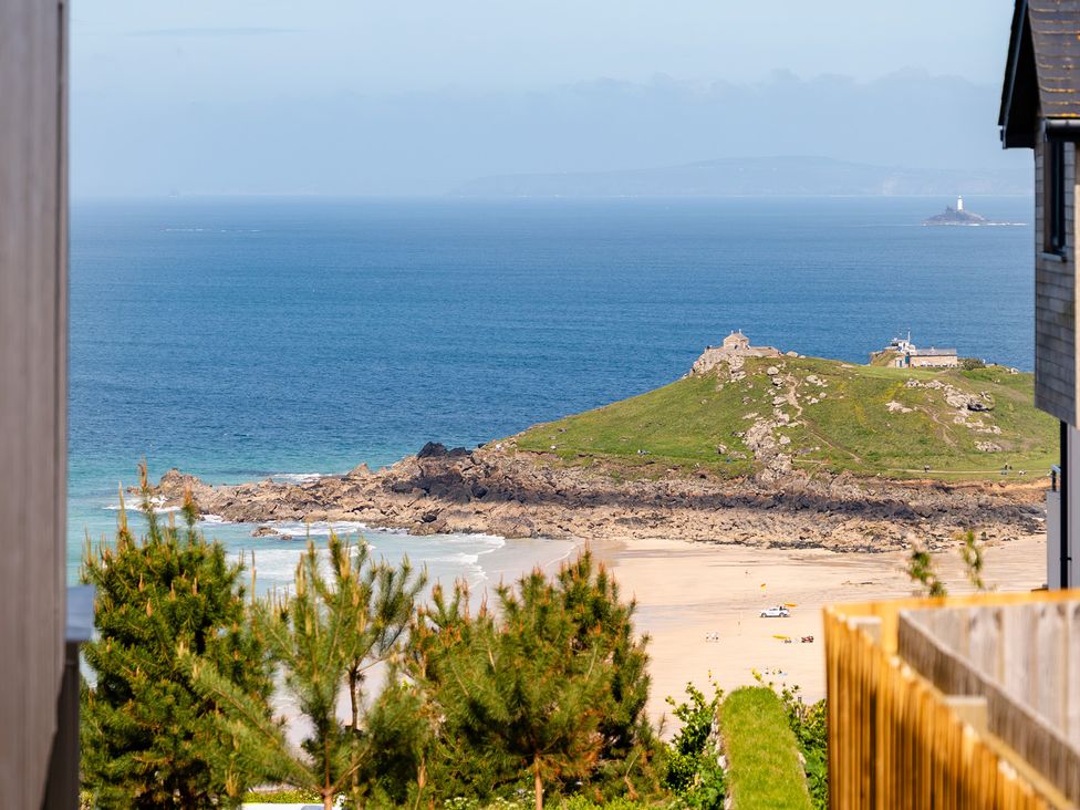 A coastal view with a beach and hill at Hidden 14- Garden Terrace St Ives