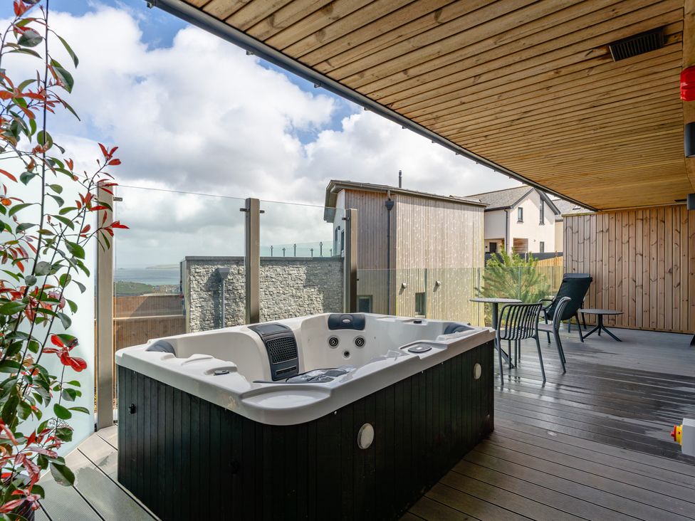 An outdoor area with a hot tub and seating at tbc in St. Ives