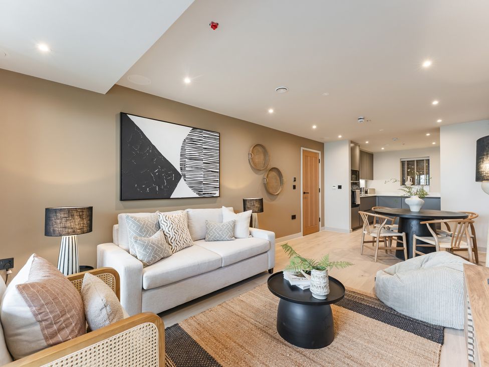 A living room with a sofa and dining table at tbc in St. Ives