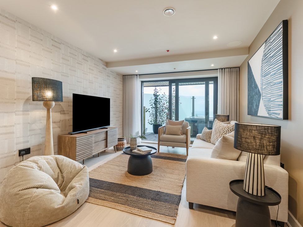 A living room with a television and seating area at tbc in St. Ives