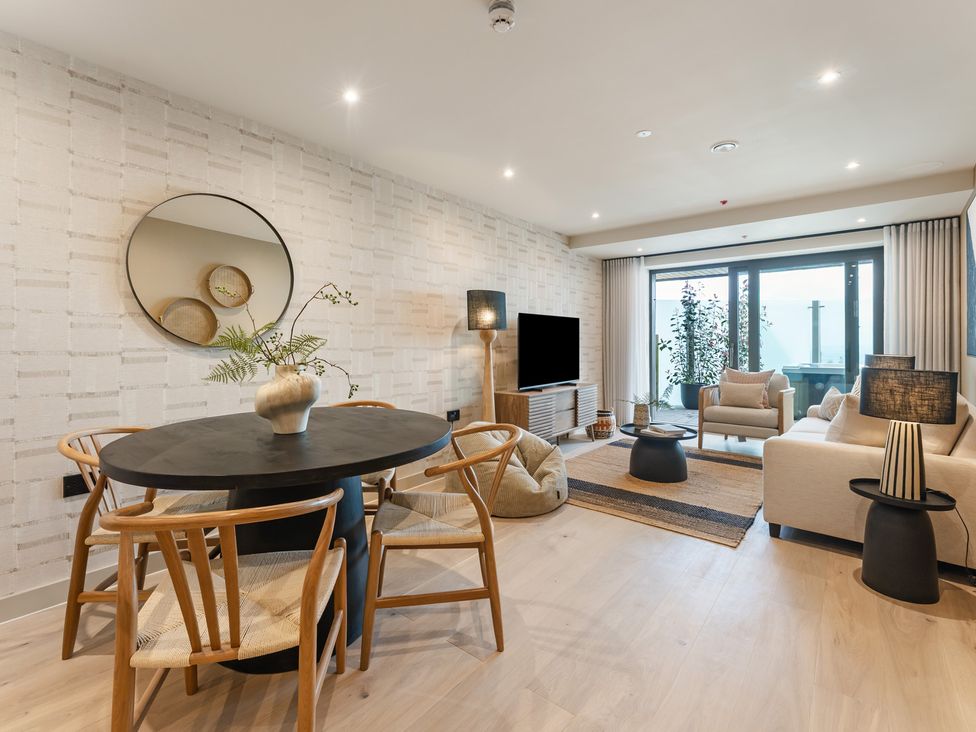 A living room with a dining table and seating area at tbc in St. Ives