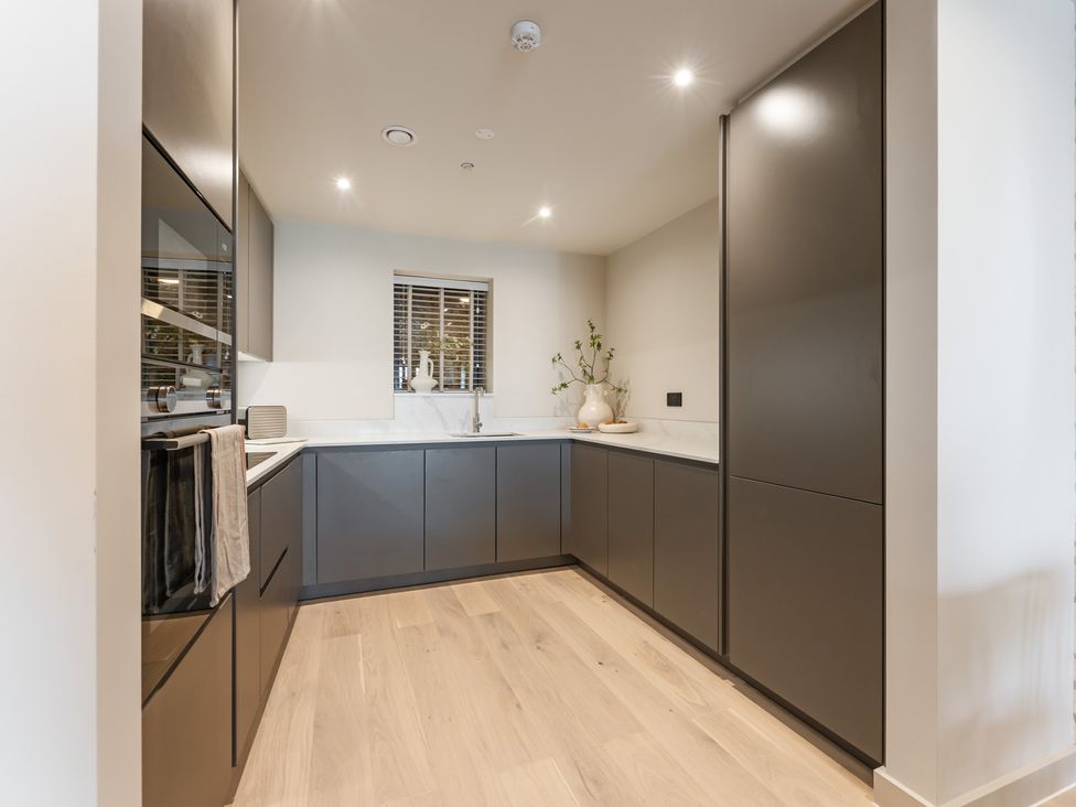 A kitchen with cabinets and a sink at tbc in St. Ives