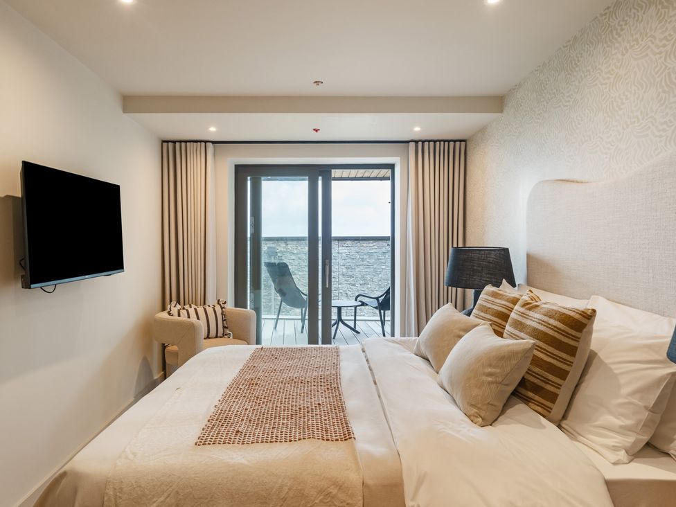 A bedroom with a bed and television at tbc in St. Ives