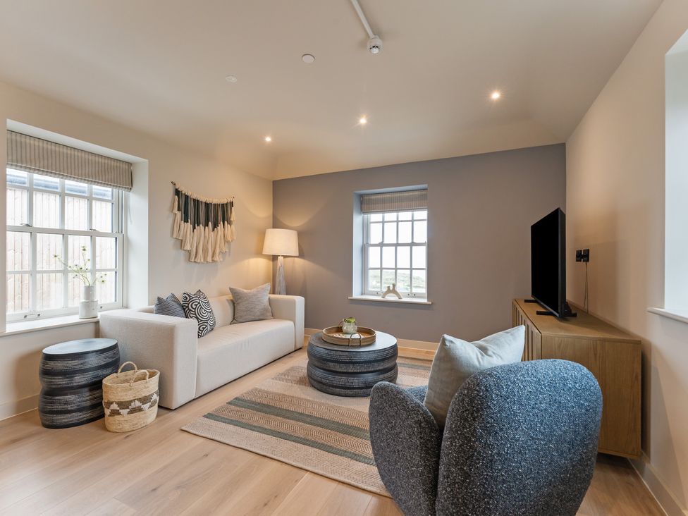 A living room with a sofa and television at tbc in St. Ives