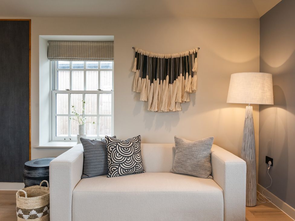 A living room with a sofa and decorative items at tbc in St. Ives