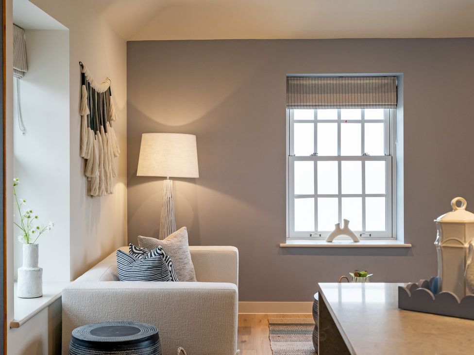 A living room with a sofa and a lamp at tbc in St. Ives