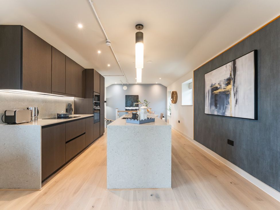 A kitchen with cabinets and an island at tbc in St. Ives