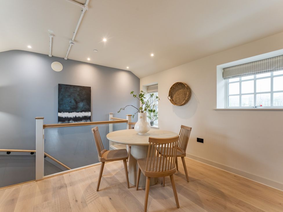 A dining room with a round table and chairs at tbc in St. Ives