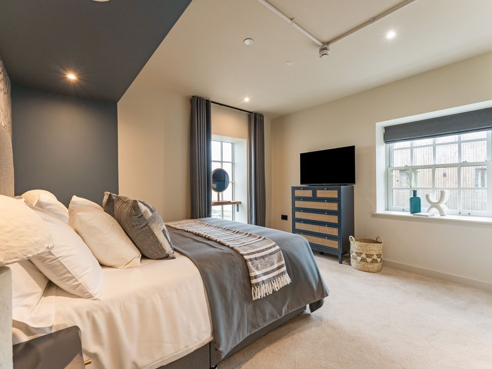 A bedroom with a bed and television at tbc in St. Ives